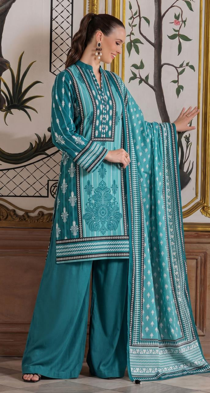 A woman modeling a teal printed lawn kurta and matching pants from GulAhmed Summer Collection, shown against an ornate indoor backdrop with a product information panel on the right.