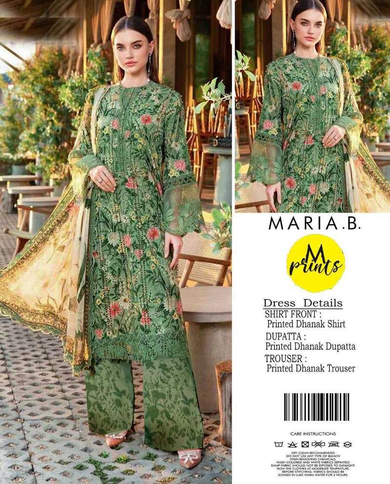 Green floral dress with dupatta by Maria B. on a blurred outdoor background