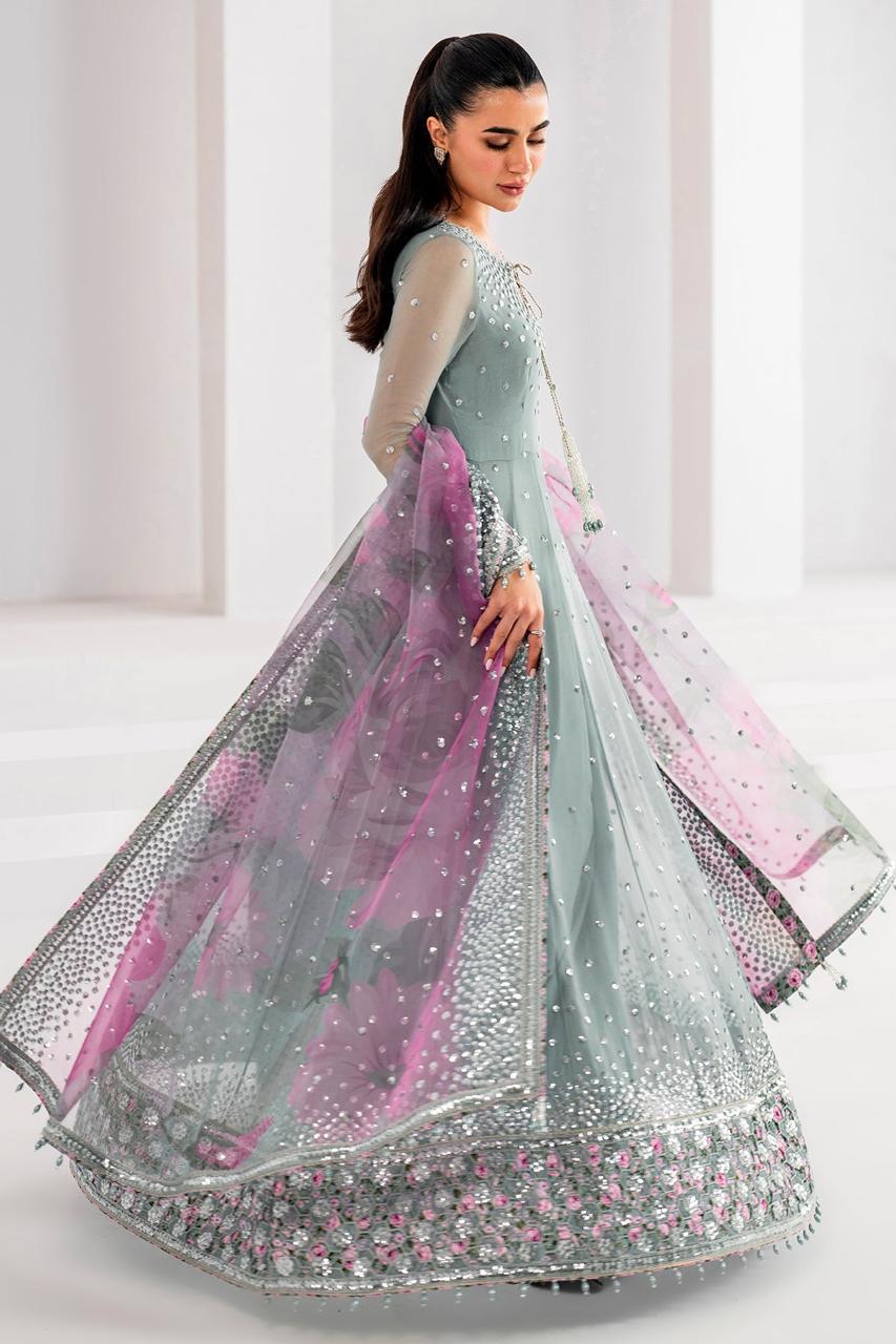 Woman wearing a gray and pink traditional outfit with a white background