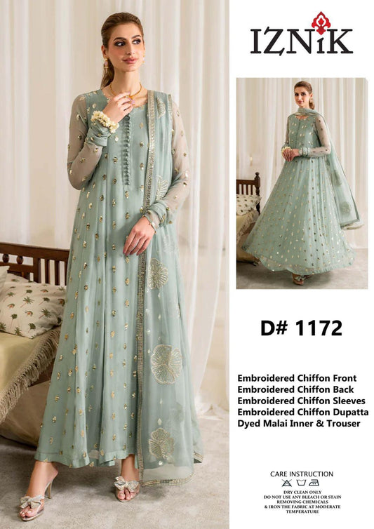 Woman wearing a light blue embroidered outfit with 'Iznik' branding on a white background.