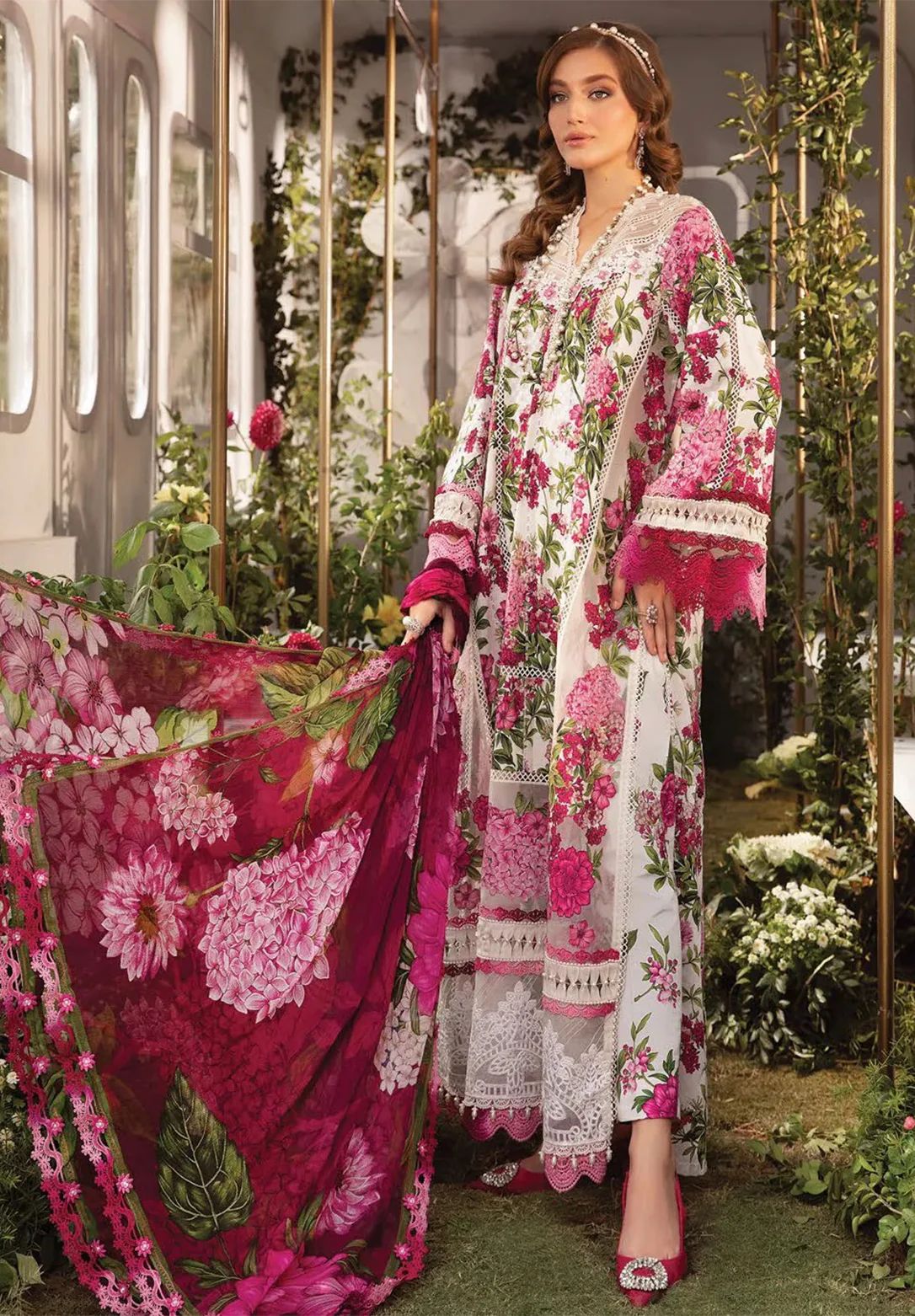 Woman in a floral outfit with a pink dupatta in an outdoor setting