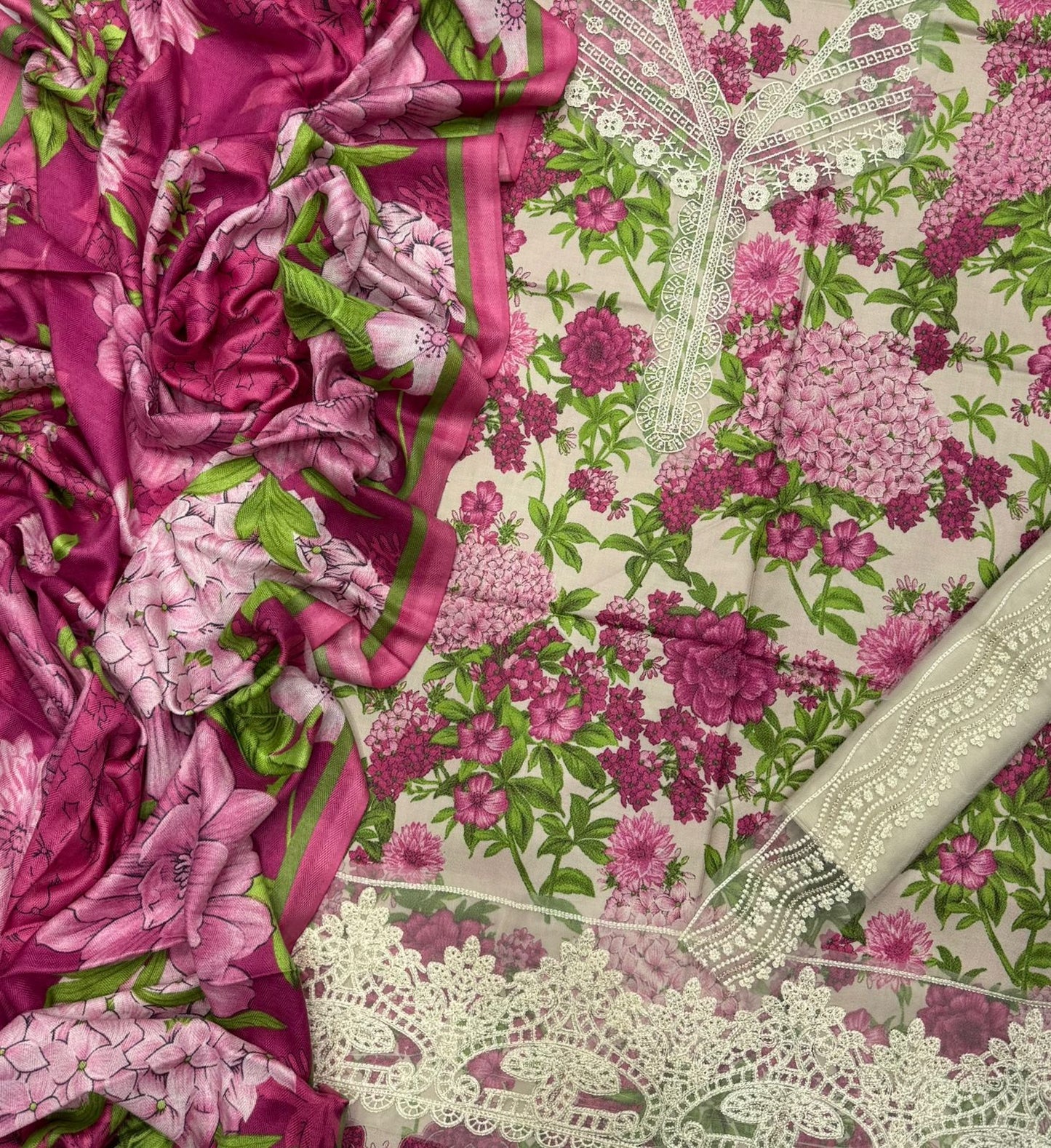 Close-up of a fabric with pink floral patterns and lace details