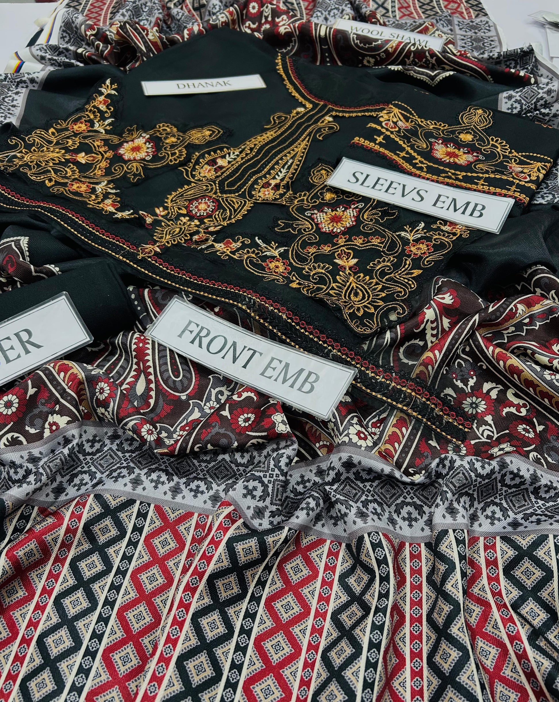 Embroidered fabric with labels indicating 'Front Emb' and 'Sleeve Emb'.