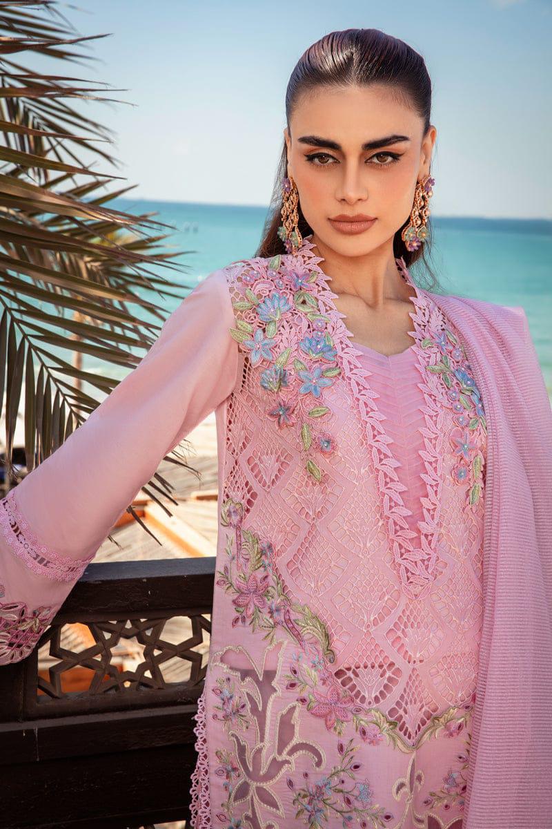 Woman in a pink embroidered outfit with a scenic background