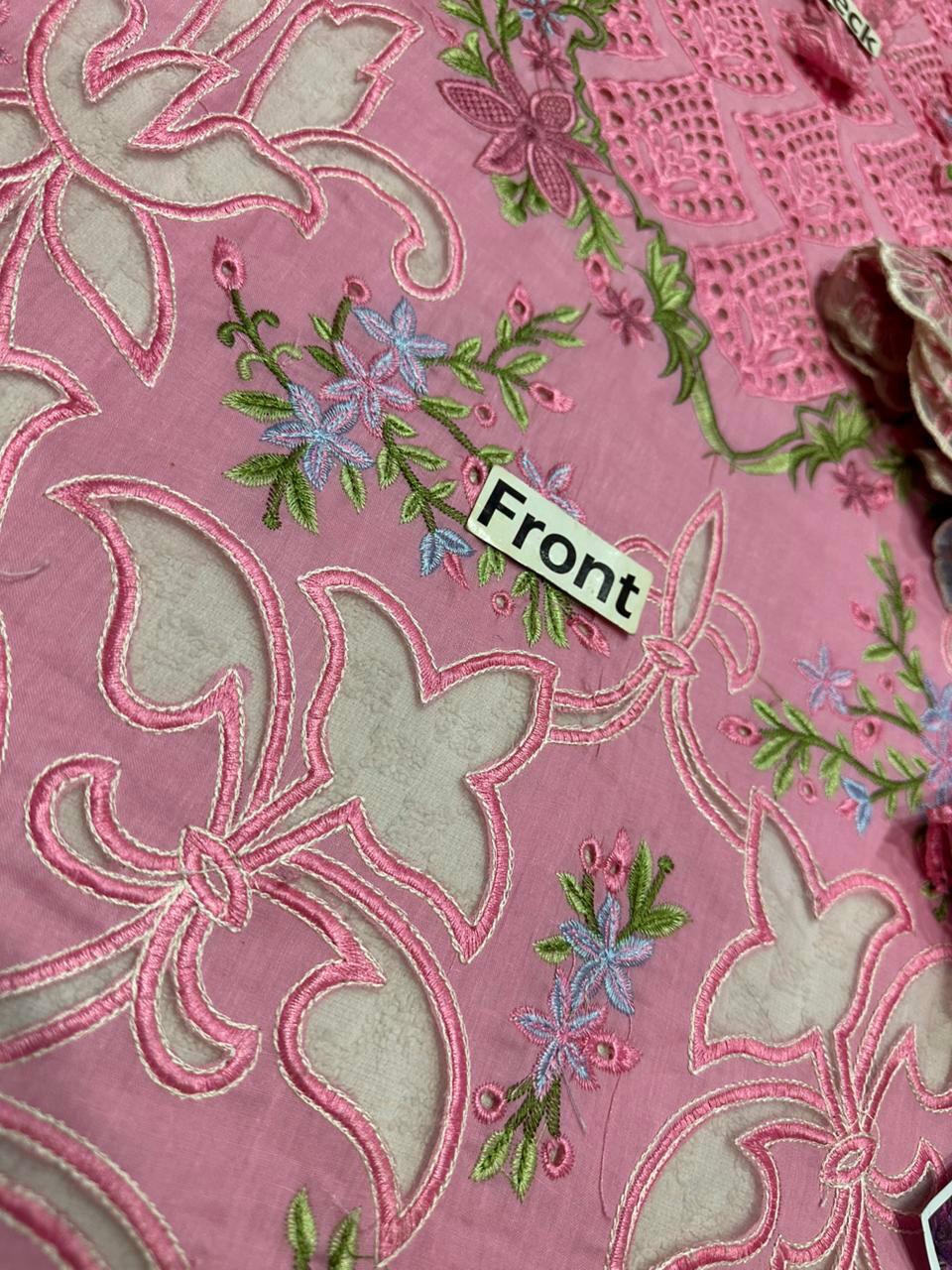 Embroidered fabric with floral patterns and a 'Front' label on a pink background