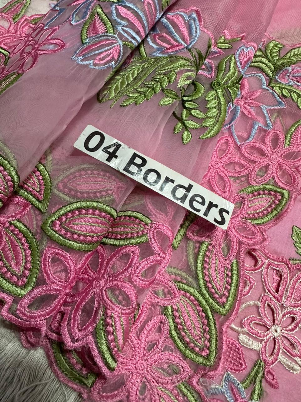 Pink fabric with green floral embroidery and a label reading '04 Borders'.