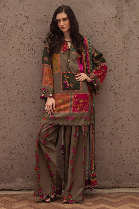 Woman wearing a traditional outfit with floral patterns against a textured wall.