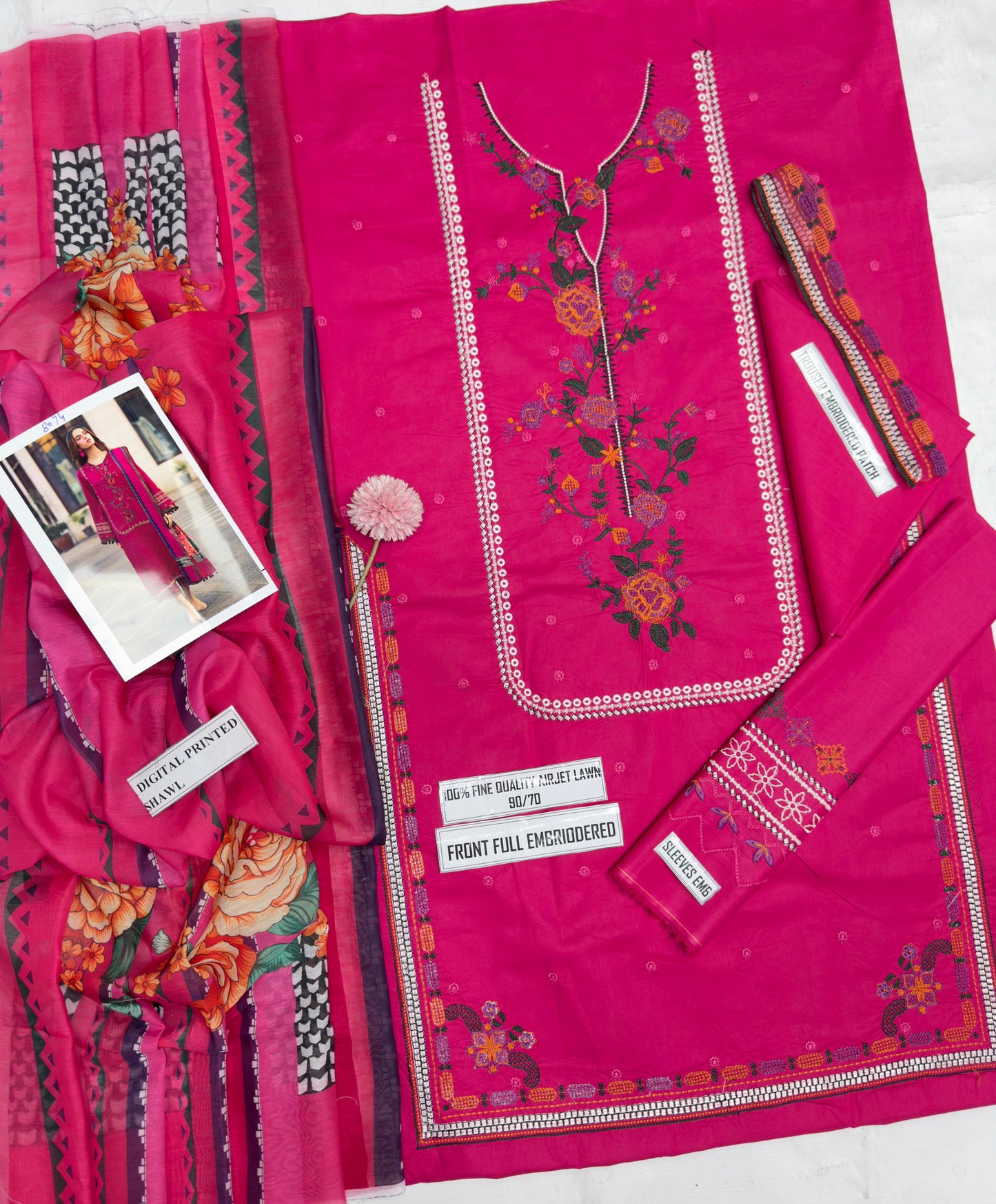 Pink embroidered fabric with floral patterns on a white background