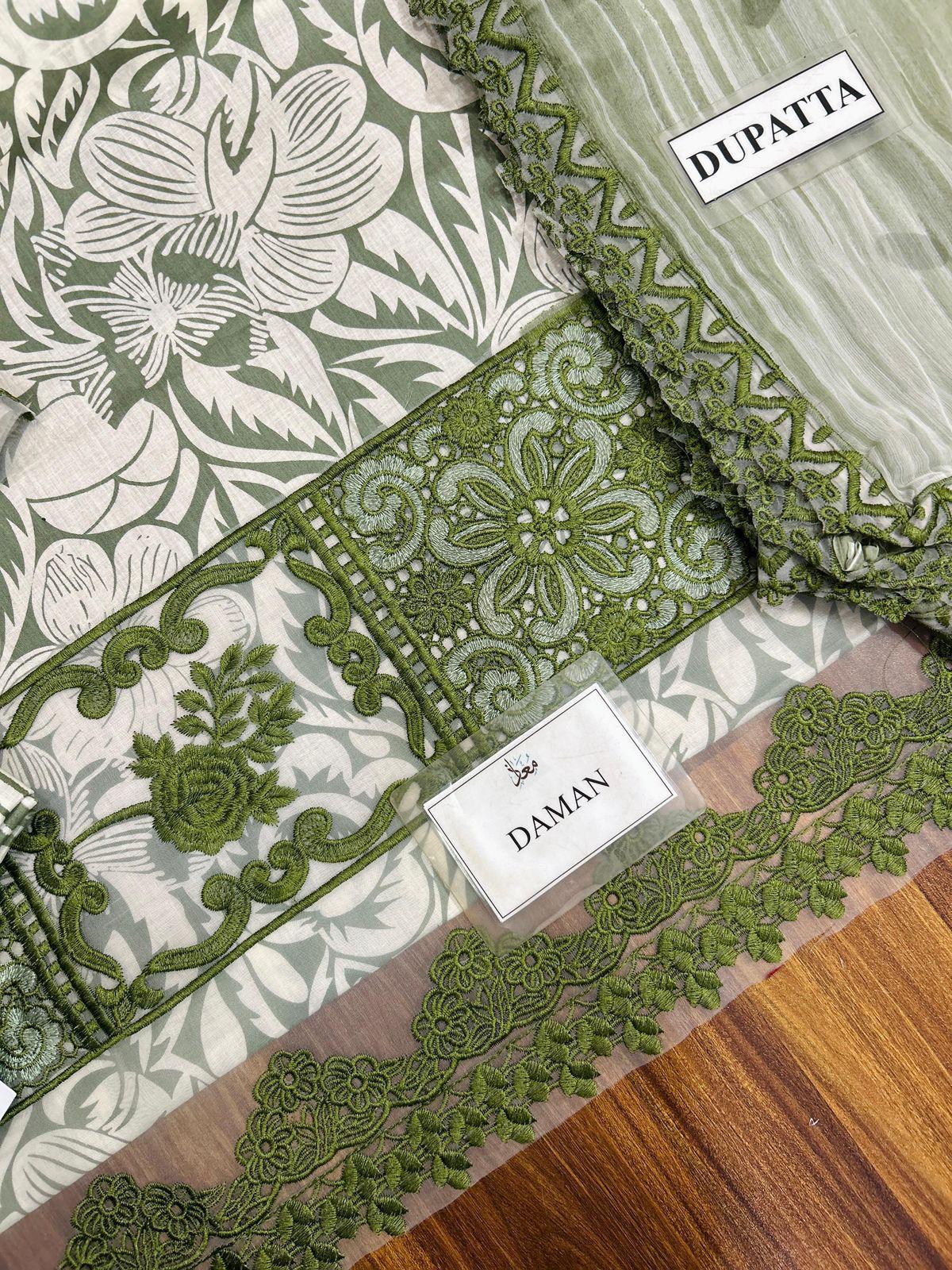 Green and white floral dupatta with embroidery on a wooden surface