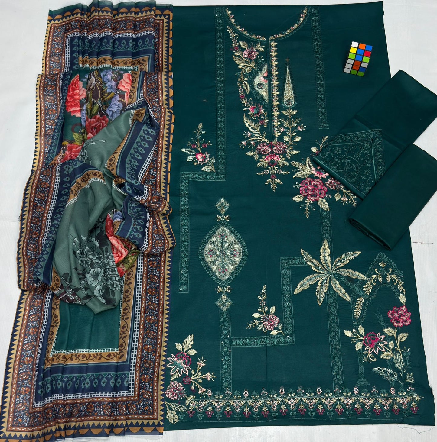 Embroidered fabric with floral patterns on a green background