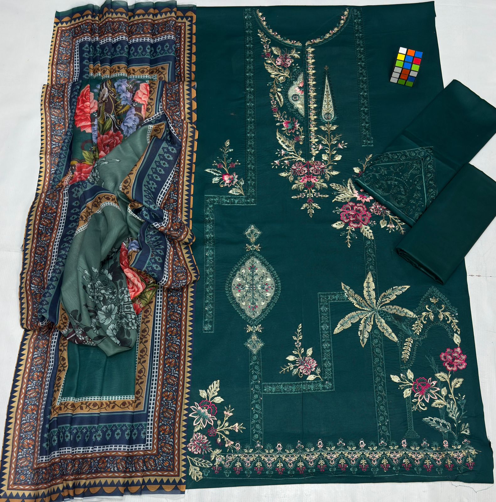 Embroidered fabric with floral patterns on a green background