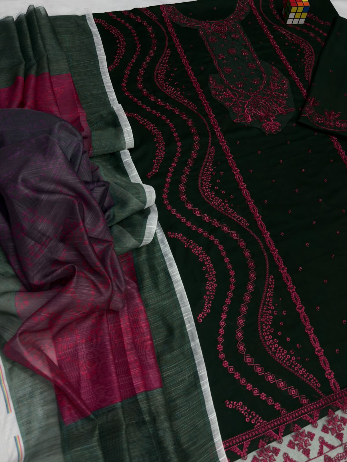 Close-up of a green and red fabric with intricate patterns