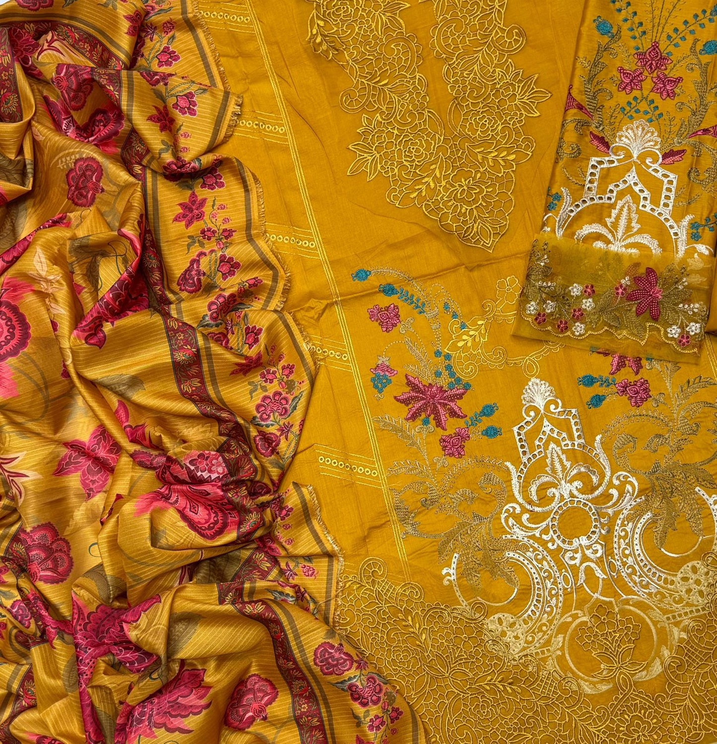Yellow fabric with intricate floral and paisley patterns