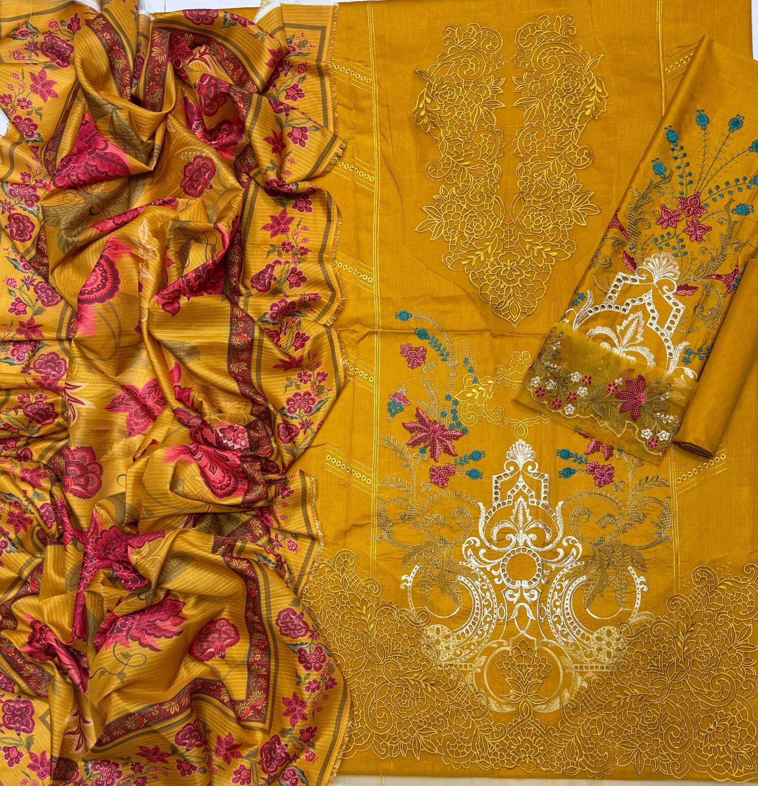 Yellow fabric with intricate floral and geometric patterns