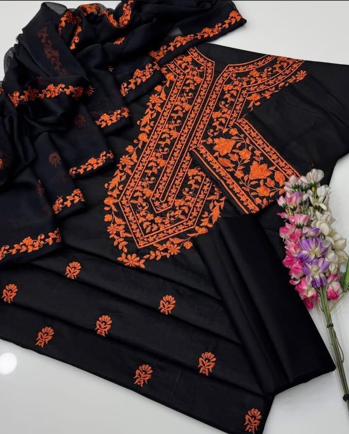 Black fabric with orange embroidery on a white background