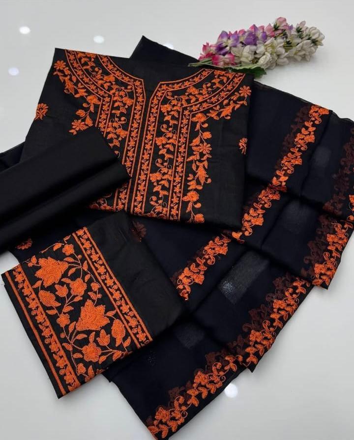 Black fabric with orange embroidery on a white background