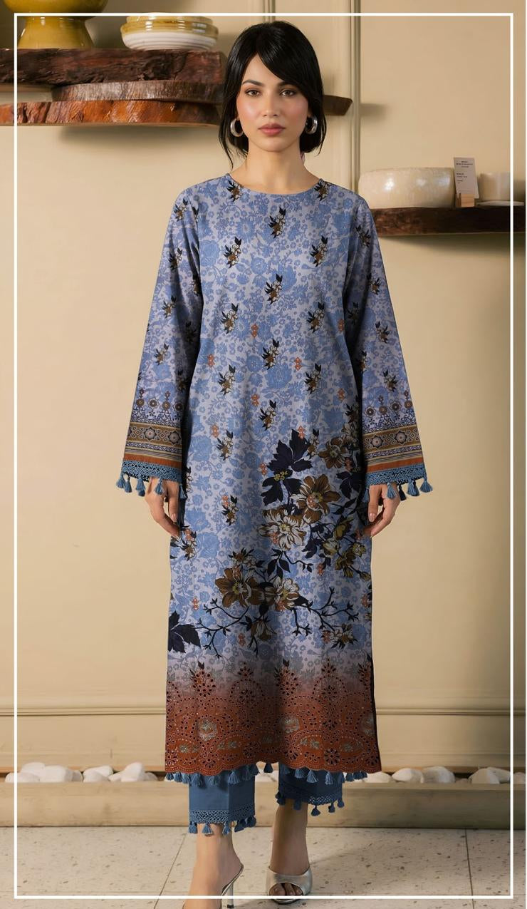 Woman wearing a blue floral embroidered shirt and pants with 'Ripple Collection' branding.