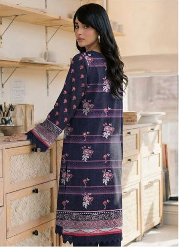 Woman wearing a navy blue and pink embroidered outfit with 'Ripple Collection' branding.
