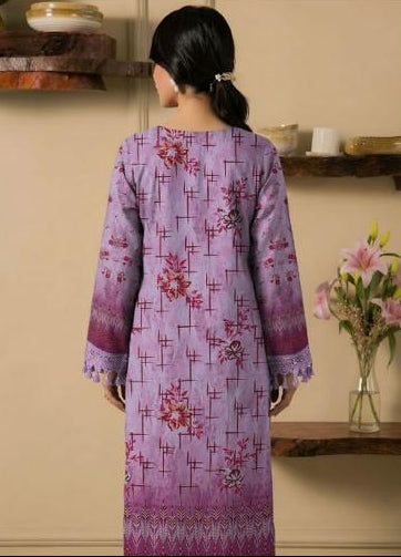 Woman wearing a purple embroidered shirt and trousers from Ripple Collection, holding flowers.