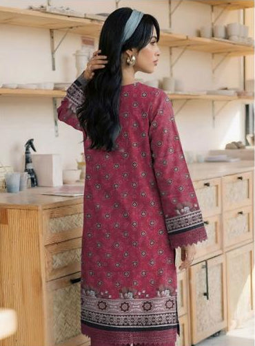Woman wearing a maroon embroidered shirt and pants in a kitchen setting, with Ripple Collection branding.