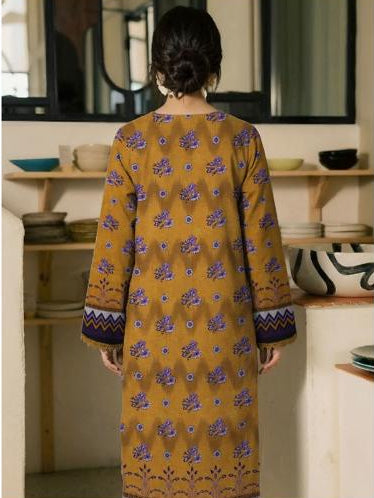 Woman wearing a patterned shirt and pants with 'Ripple Collection' branding.