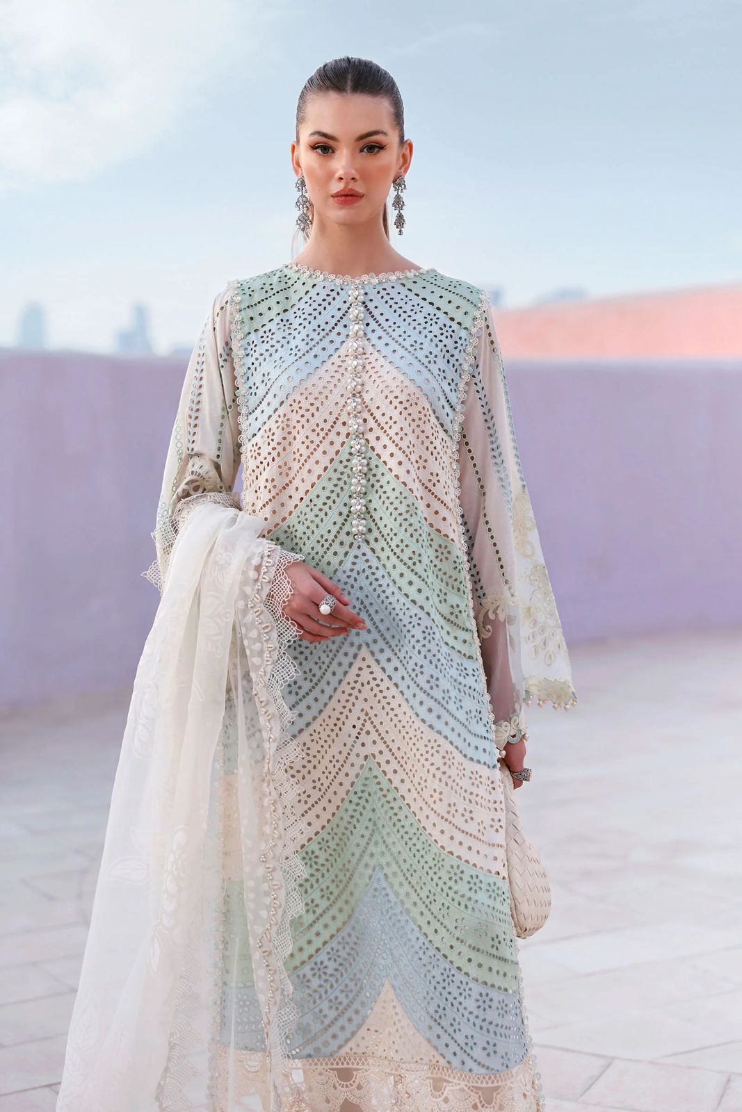 Woman wearing a colorful crocheted dress with a blurred background