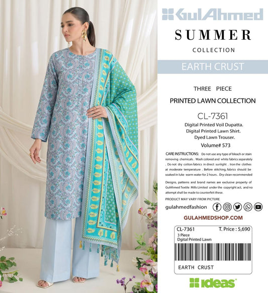 A woman modeling a three-piece printed lawn suit from GulAhmed Collection's Summer Earth Crust line, featuring a light blue patterned kurta, matching trousers, and a turquoise dupatta with yellow borders, shown next to product details on a white background.