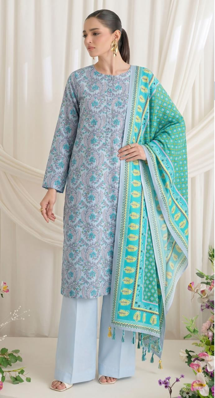 A woman modeling a three-piece printed lawn suit from GulAhmed Collection's Summer Earth Crust line, featuring a light blue patterned kurta, matching trousers, and a turquoise dupatta with yellow borders, shown next to product details on a white background.
